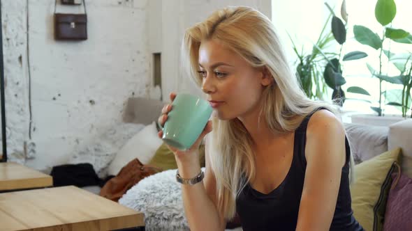 The Blonde Is Drinking Coffee