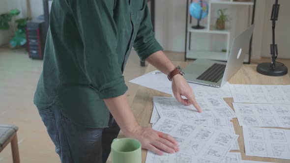 Creative Designer Works On A Storyboard, Looks At His Sketches And Concepts