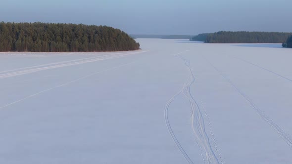 Flight Over a Taiga Forest Lake in Winter