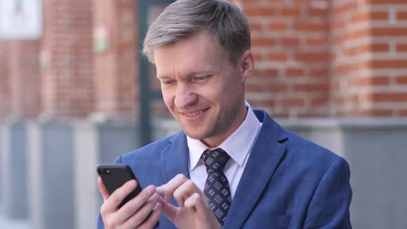 Portrait of Businessman Busy Using Smartphone