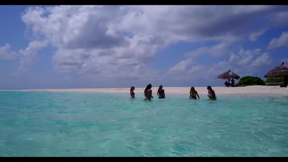 Beautiful women enjoying life on paradise island beach adventure by turquoise lagoon and white sand 
