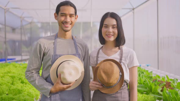 Portrait of Asian business couple farmers owner working in vegetables hydroponic farm with happiness