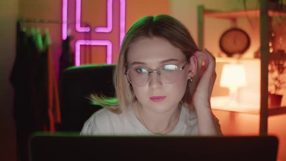 Close Up of Tired Woman Working at Night on Laptop Girl in Eye Glasses with Reflections Overworking