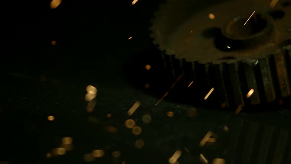 Sparks with gears in ultra slow motion 1500fps on a reflective surface - SPARKS w GEARS 020