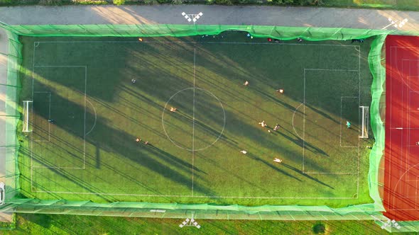 Aerial view of a sports field with footballers playing in spring, Poland