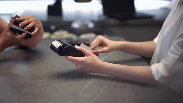 Unrecognizable Woman Using POS Terminal Cashless Payment Serving Rich Customer Admiring Jewellery