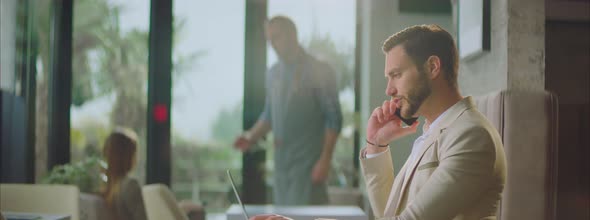 Man having call and sipping espresso