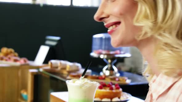 Beautiful woman having milkshake