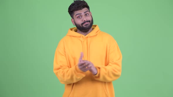 Happy Young Overweight Bearded Indian Man Clapping Hands