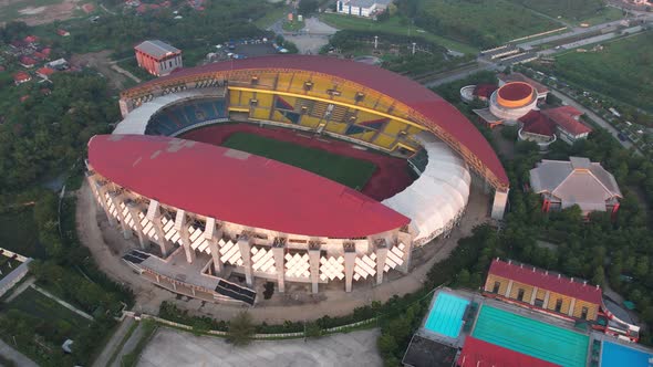 Aerial top down view of the Beautiful scenery of Wibawa Mukti Stadium when sunrise