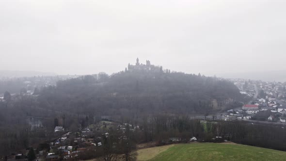 Aerial footage of Braunfels castle on a gloomy winter day. Ascending wide angle aerial view