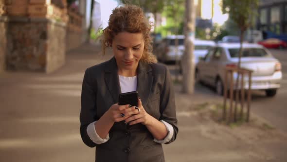 Young Caucasian Girl Using Mobile Outdoors