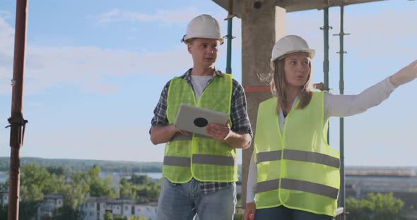 Construction Manager and Engineer Working on Building Site