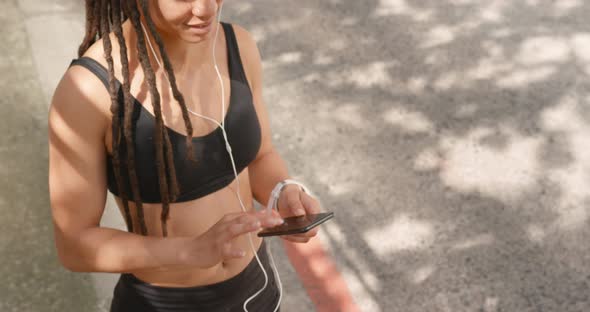 Front view of African American woman using mobile phone in the city 4k