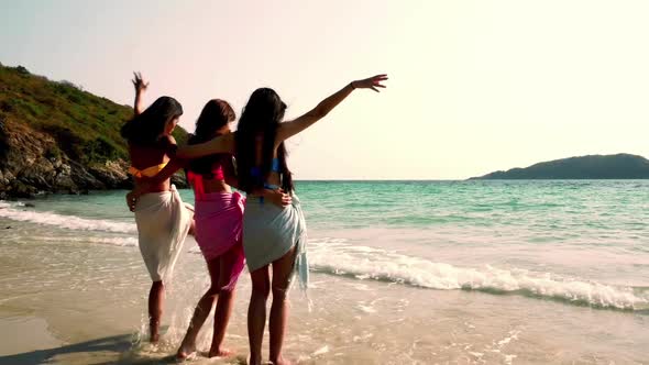 Group of friends standing and having fun on the beach