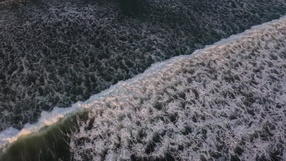 Ocean and rolling giant waves with white foam. Bali island, Indonesia. Aerial slow motion shot.High