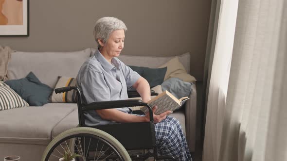 Handicapped Woman Reading by Window