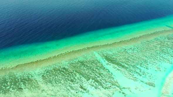 Aerial drone panorama of tropical resort beach holiday by blue lagoon with white sandy background of