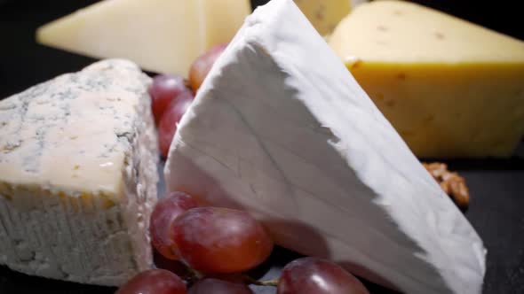 Cheese Plate Closeup with Several Varieties of Fruit and Cheese