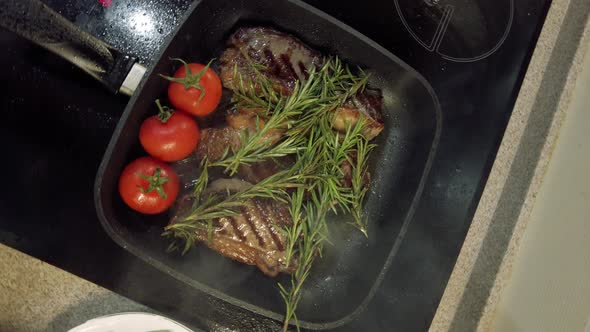 Cooking Steak with Rosemary and Cherry Tomatoes on the Grill