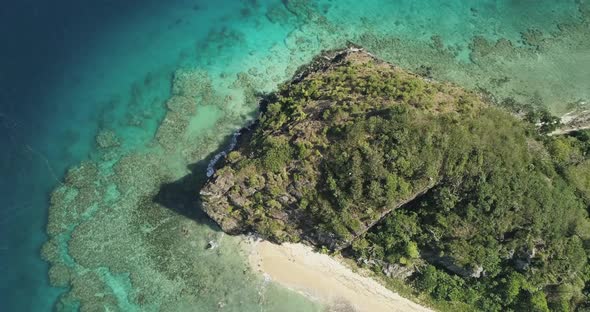 Aerial footage of ocean and land on an island in Tonga. Coral reef system.