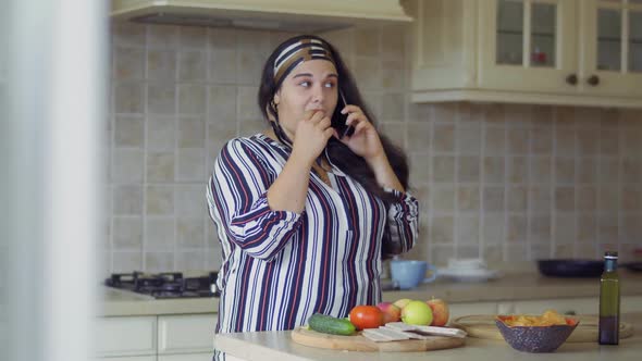 Plump Girl Is Cooking in the Kitchen