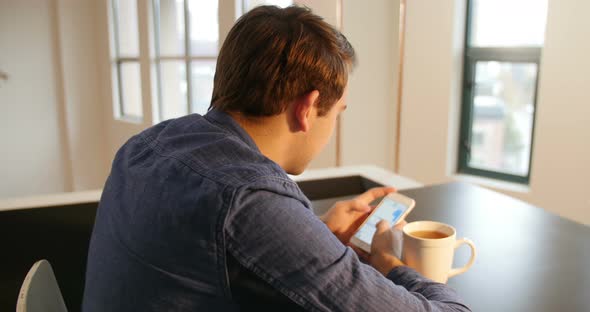 Man using mobile phone with black coffee on table