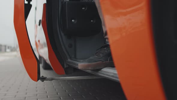 Legs of Passengers Getting off Bus