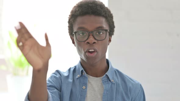 Portrait of Young African Man Waving Welcoming