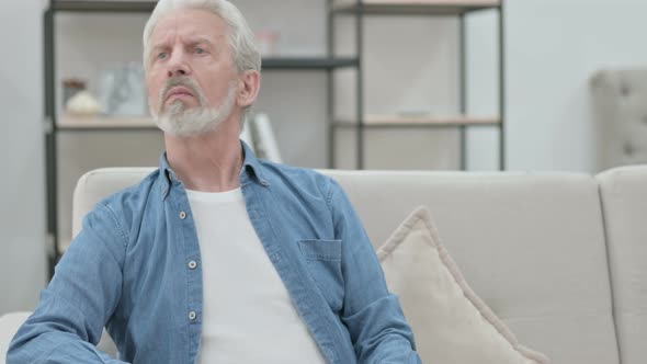 Old Man Checking Watch While Waiting on Sofa