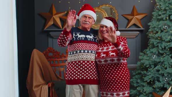 Mature Senior Christmas Family Smiling Friendly at Camera Waving Hands Gesturing Hello or Goodbye