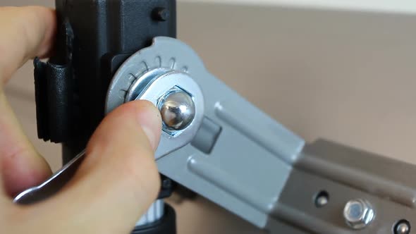 Close-Up of Hands Tightening Nut Fastener with A Hexagonal Ratchet Wrench