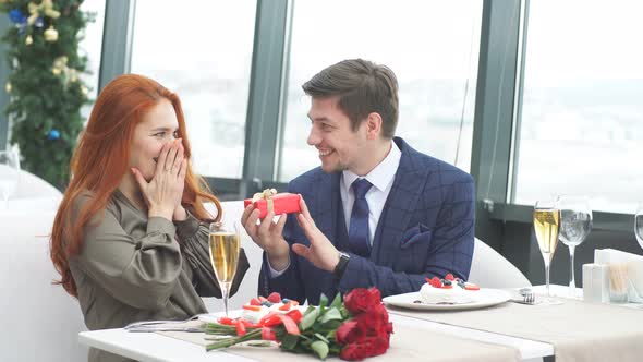 Surprised Woman and Gallant Man in Restaurant