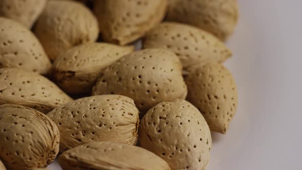 Cinematic, rotating shot of almonds on a white surface - ALMONDS