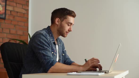 Happy Freelancer Relieved to Have Met Deadline Finish Work on Laptop Sitting at Desk at Home Office