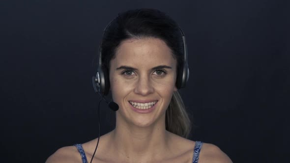 Woman wearing headset, smiling cheerfully