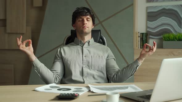 Man Meditating in Office Coping with Stress