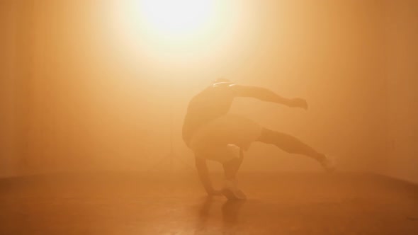 Young Hipster Bboy Doing Breakdancing Practice in Dance Studio