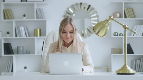 Smiling woman communicating with colleagues online