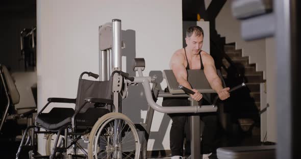 Disability Exercises: disabled person performs rehabilitation exercises in gym.