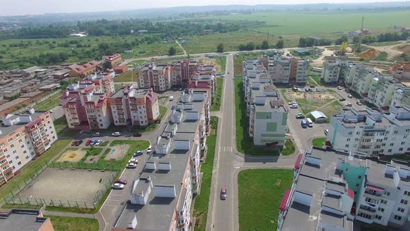 Cars are Passing Along the Road of the New District of the City