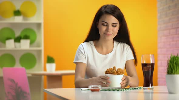 Smiling Woman Holding Disposable Bowl With Crispy Fried Chicken, Enjoying Smell