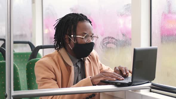 African American Student in Mask Using Public Transport