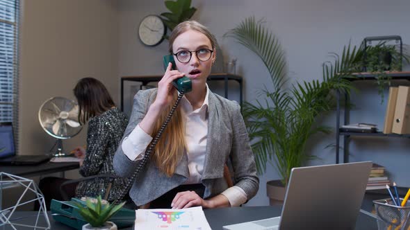 Annoyed Young Businesswoman Talking on Retro Telephone Call Irritated Voice Dissatisfied with Work