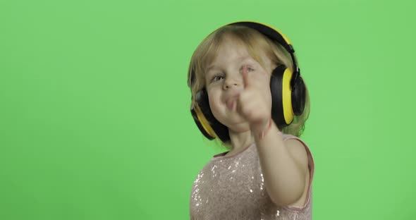 Girl in Glossy Dress and Headphone Listening To Music and Dancing. Chroma Key