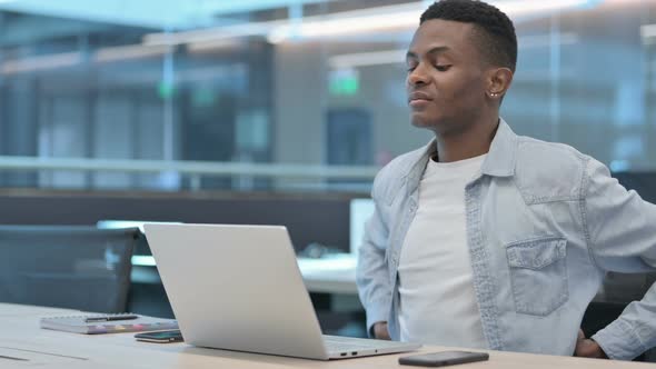 African Man with Laptop having Back Pain