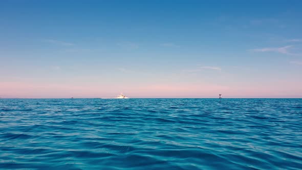 Low-angle view of speedboat traveling on blue ocean sea waters