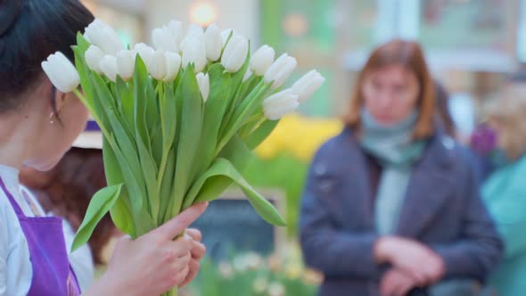 A Woman Collects a Bouquet of Tulips in Flower Market. Flower Delivery, Order Creation, Small
