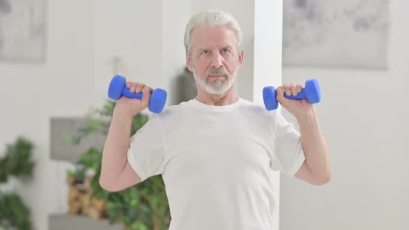 Close Up of Loving Old Man Working Out with Dumbbells