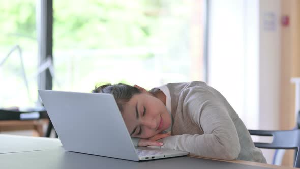 Tired Indian Woman with Laptop Taking Nap at Work 